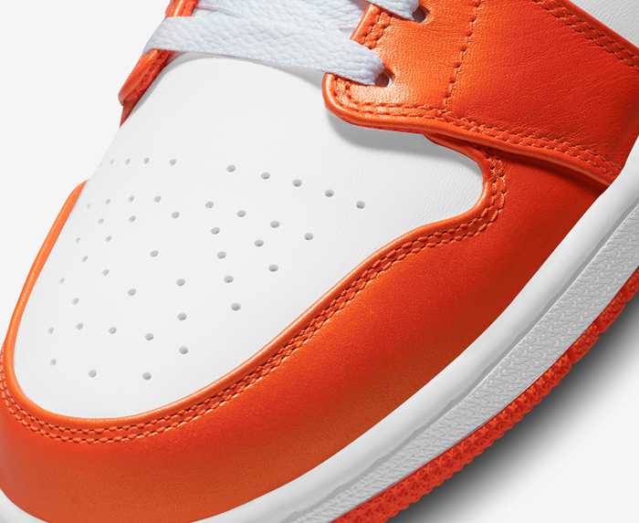 Nike Air Jordan 1 Mid sneakers in orange and black